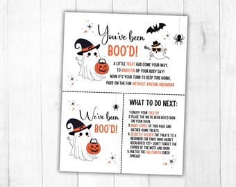 May include: A white paper flyer with black and orange Halloween graphics including ghosts, a bat, a spider, and a pumpkin bucket. The text reads You've been BOO'D, A little treat has come your way, and What to do next with numbered instructions.