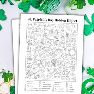 May include: A black and white St. Patrick's Day Hidden Object game sheet with a checklist of items to find. The sheet is surrounded by green shamrock decorations and gold glitter.