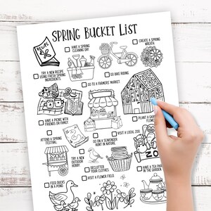 May include: Black and white "Spring Bucket List" printable with illustrations of spring activities. A hand with a blue pen is checking off boxes. The list includes activities like "Go Bike Riding" and "Visit a Local Zoo".