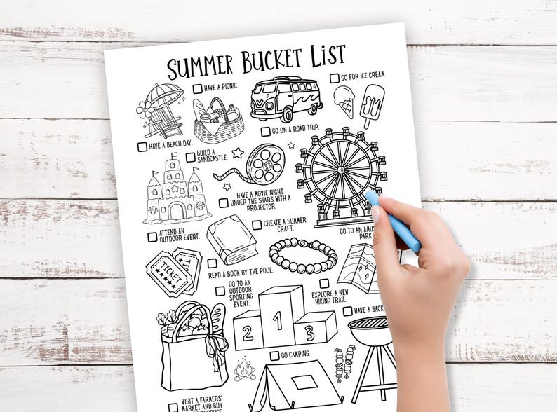 May include: Black and white summer bucket list with illustrations of summer activities, including a picnic, beach day, road trip, and more. A hand with a blue crayon is marking an item on the list.