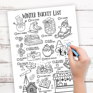 May include: Black and white winter bucket list with illustrations of winter activities, including ice skating, sledding, and baking cookies. A hand with a blue crayon is drawing on the list.