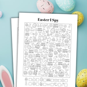 May include: Two sheets of white paper featuring an "Easter I Spy" game. The game includes Easter-themed illustrations like eggs, bunnies, and flowers. The background is light blue with colourful Easter eggs.