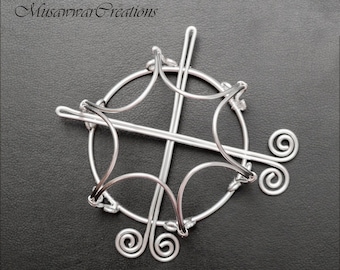 May include: Silver wire hair clip with a circular design and three spiral accents.