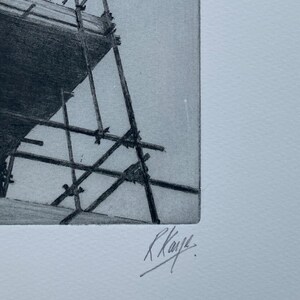May include: A black and white pencil drawing of a scaffolding structure. The drawing is signed "R. Kaye."