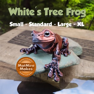 May include: A brown and black frog figurine labeled "White's Tree Frog" is perched on a stone. The text "Small - Standard - Large - XL" is above the frog. The MatMire Makes logo is visible.