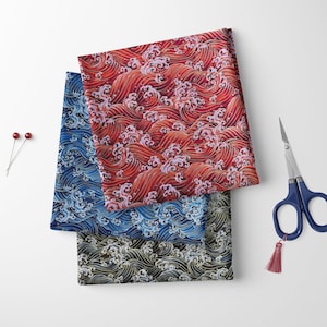 May include: Three pieces of fabric with a wave pattern. The fabric is red, blue, and black with gold accents. The fabric is folded on top of each other.