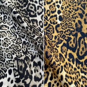 May include: Two fabric swatches with a leopard print pattern. The fabric on the left is a light brown and black leopard print. The fabric on the right is a dark brown and black leopard print.