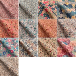 May include: A collection of 12 different cork fabric swatches featuring various floral and leaf patterns in shades of red, pink, blue, green, and brown.