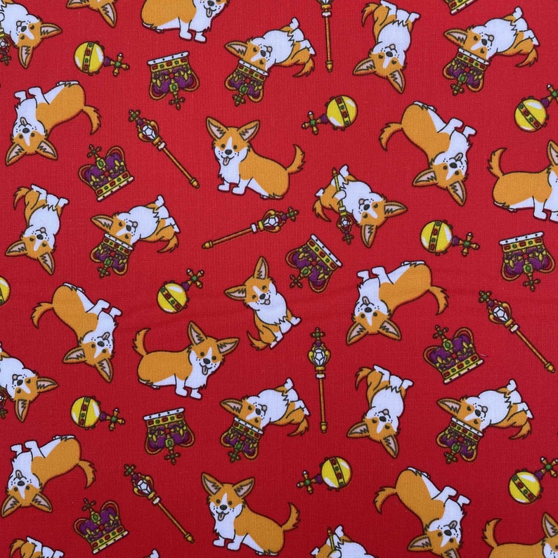 May include: A red fabric with a repeating pattern of cartoon corgis wearing crowns and holding scepters. The corgis are in various poses, some are sitting, some are standing, and some are running. The background is a solid red color.