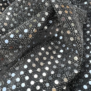 May include: Black fabric with silver sequins in a polka dot pattern.