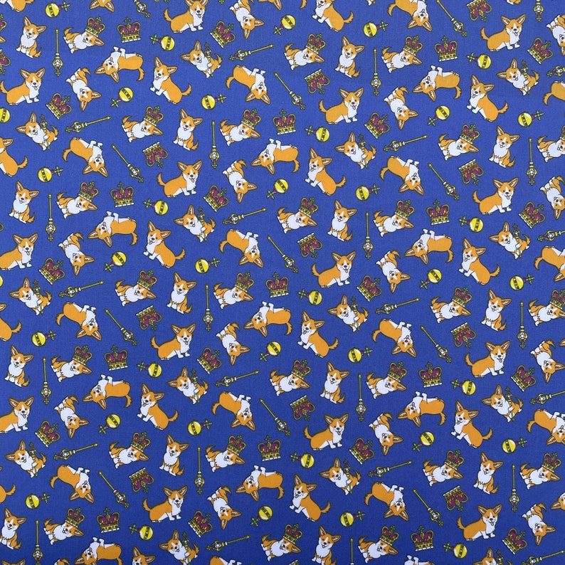 May include: A blue fabric with a repeating pattern of cartoon corgis wearing crowns. The corgis are in various poses, some sitting, some standing, and some running. The crowns are gold and have red jewels. The background is a solid blue.