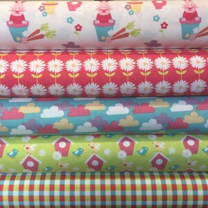 May include: Five rolls of fabric with different patterns. The top roll has a white background with pink bunnies in flower pots, the second roll has a pink background with white flowers, the third roll has a light blue background with white clouds, the fourth roll has a green background with pink birdhouses and blue birds, and the bottom roll has a red and white checked pattern.