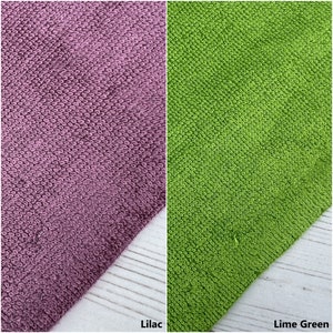 May include: Two fabric swatches, one lilac and one lime green. The fabric is a textured terry cloth.
