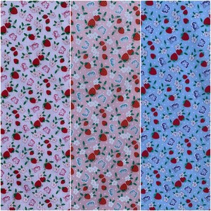 May include: A seamless fabric pattern featuring a repeating design of red strawberries, white flowers, and pink butterflies on a light pink background.