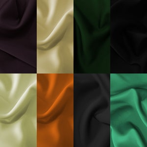 Könnte beinhalten: Eine Sammlung von Stoffproben in verschiedenen Farben, darunter Schwarz, Grün, Orange und Creme. Der Stoff hat eine glatte, seidige Textur.