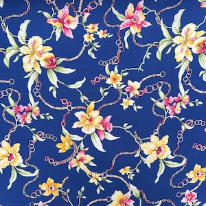 May include: A blue fabric with a floral pattern featuring yellow and pink flowers, and gold chains. The flowers are stylized and have a vintage feel.