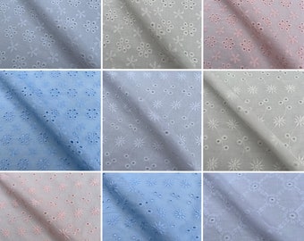 May include: A collection of nine fabric swatches in various shades of blue, pink, and white. Each swatch features a delicate eyelet pattern with small floral designs.