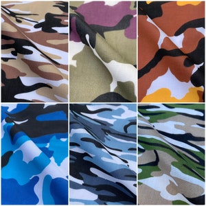 May include: Six fabric samples showcasing different camouflage designs. The colour schemes include brown, tan, black, white, green, blue, and purple. The fabric is folded, revealing the texture and design variations.