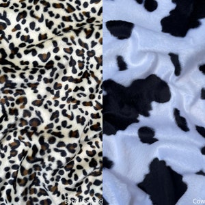 May include: Close-up of two fabric swatches. The left swatch is a white fabric with a brown and black leopard print. The right swatch is a white fabric with a black and white cow print. The text "Baby Leopard" is below the left swatch and the text "Cow" is below the right swatch.