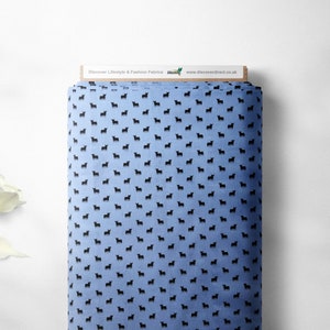 May include: Blue fabric with a repeating pattern of black bull silhouettes. The fabric has a Discover Lifestyle & Fashion Fabrics label with the website www.discoverdirect.co.uk.