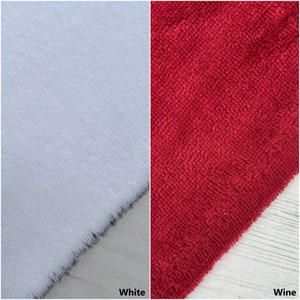 May include: Two fabric swatches, one white and one wine red. The swatches are textured and have a fuzzy appearance.