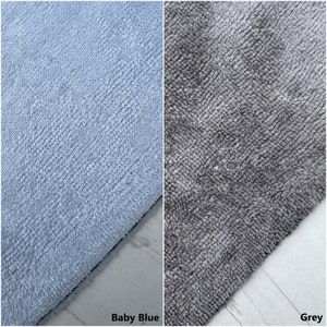 May include: Two close-up images of fabric swatches. The first swatch is a soft, light blue, and the second swatch is a dark grey.