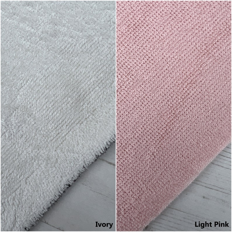 May include: Two fabric swatches, one ivory and one light pink. Both swatches are made of a soft, textured material.