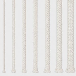 May include: A collection of white braided ropes of varying thicknesses, arranged vertically against a plain background. The ropes have a textured appearance, with a slightly frayed base. The image showcases the different sizes and textures of the ropes.