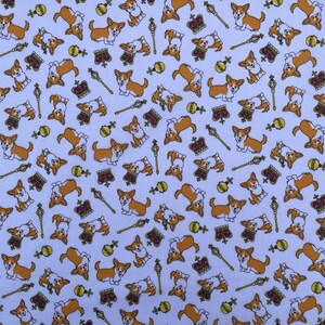 May include: A white fabric with a repeating pattern of cartoon corgis wearing crowns. The corgis are brown and white with black noses and eyes. The crowns are gold with purple jewels. The background is white with a subtle texture.