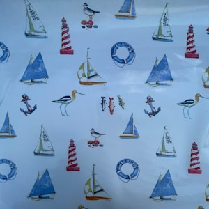 May include: A blue and white nautical themed fabric with a repeating pattern of sailboats, lighthouses, anchors, birds, and fish. The fabric has a light blue background with white accents.