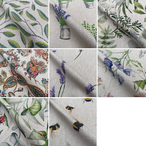 May include: A collection of fabric swatches featuring various floral and nature-inspired patterns. The swatches include designs with lavender, bees, leaves, and paisley patterns. The fabric is a light beige linen blend.