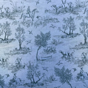 May include: A blue and white toile fabric with a repeating pattern of hunting dogs, birds, trees, and other nature scenes. The fabric has a vintage feel and would be perfect for a variety of home decor projects.