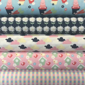 May include: Five rolls of fabric with different patterns. The top roll is light blue with a white and red pattern of small animals in flower pots. The second roll is dark blue with a white daisy pattern. The third roll is white with a pink and yellow cloud pattern. The fourth roll is pink with a green birdhouse and red bird pattern. The bottom roll is a pink and yellow gingham pattern.