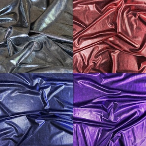 May include: Four swatches of iridescent fabric in different colors: silver, red, blue, and purple. The fabric has a shiny, metallic finish.