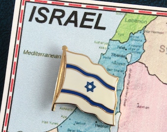 May include: A map of the Middle East with a gold pin of the Israeli flag on the country of Israel. The map shows the countries of Syria, Lebanon, Jordan, and Egypt. The map is labeled with the names of the countries and major cities.