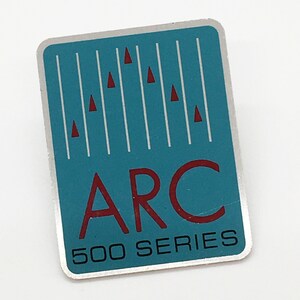 May include: A silver and blue sticker with the text "ARC 500 SERIES" in red and black lettering. The sticker has a design of vertical lines with red triangles.