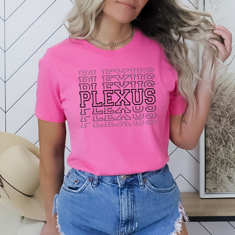 May include: A pink t-shirt with a black graphic that says "PLEXUS" in a stacked, repeating pattern.