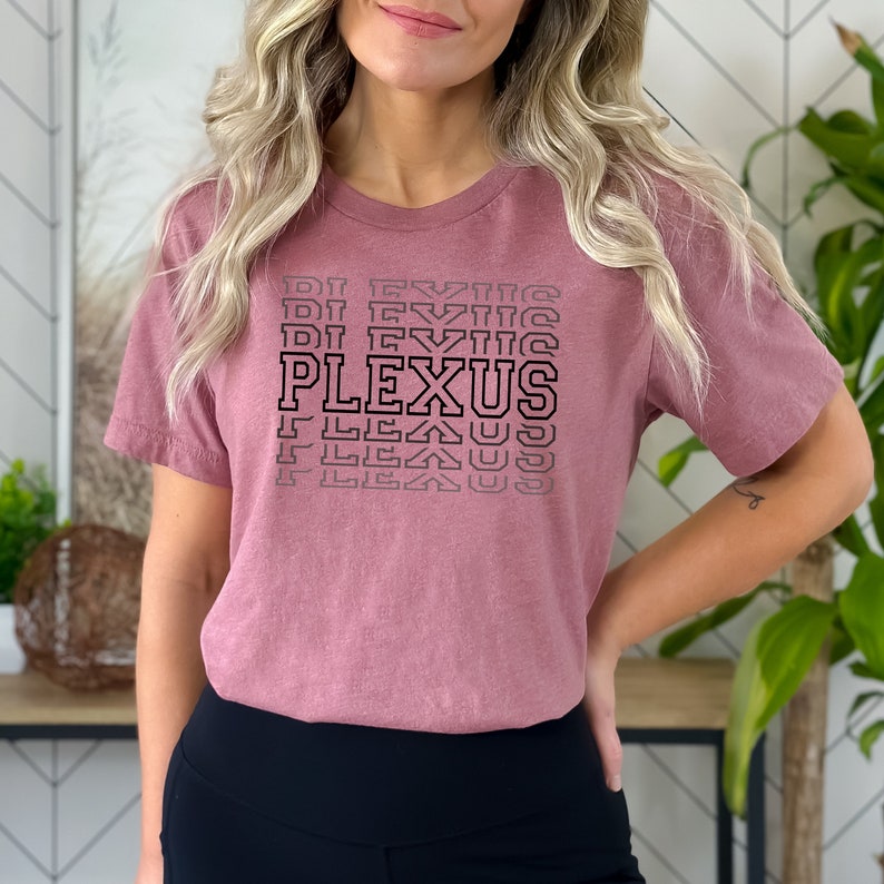 May include: A mauve coloured t-shirt with a black graphic that says "PLEXUS" in a stacked, repeating pattern.