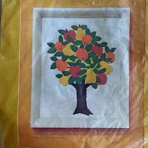 May include: Embroidered fruit tree design in a white wooden frame. The tree features red apples, yellow pears, and orange fruits with green leaves. The tree trunk is brown. The image is in a plastic package.