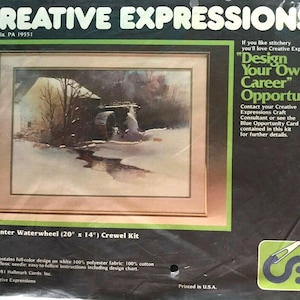 May include: A Creative Expressions 1042 Winter Waterwheel crewel kit in original packaging. The package features a printed image of a waterwheel in a snowy landscape, the text Design Your Own Career Opportunity, and lists dimensions of 20 inches by 14 inches.