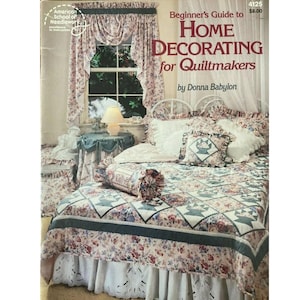 May include: A book cover titled "Beginner's Guide to Home Decorating for Quiltmakers" by Donna Babylon. The cover features a bedroom scene with floral bedding, curtains, and a table. The book is from the American School of Needlework.