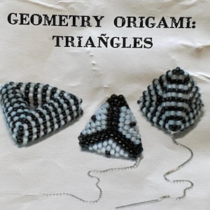 May include: The image displays three beaded geometric shapes: a triangle, a curved triangle, and a rounded triangle. The beads are black, white, and light blue. The text at the top reads "Geometry Origami: Triangles". Each shape has a silver chain attached.