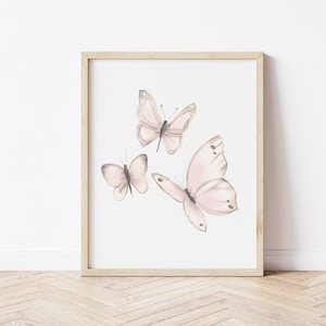 May include: A framed print featuring three delicate pink butterflies with gray outlines, set against a white background.