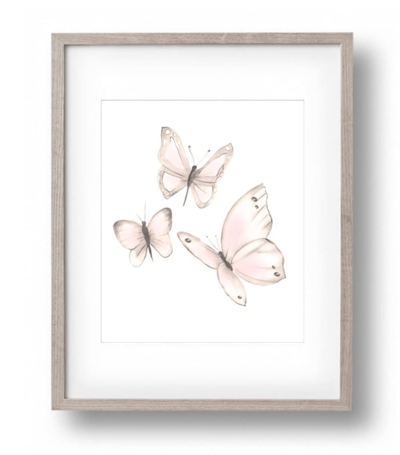 May include: A framed print featuring three delicate pink butterflies with watercolor-like details on a white background.