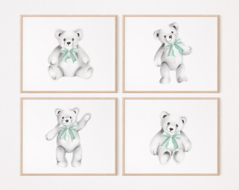 May include: Set of four framed prints featuring watercolor illustrations of teddy bears with green bows. Each print is set against a white background.