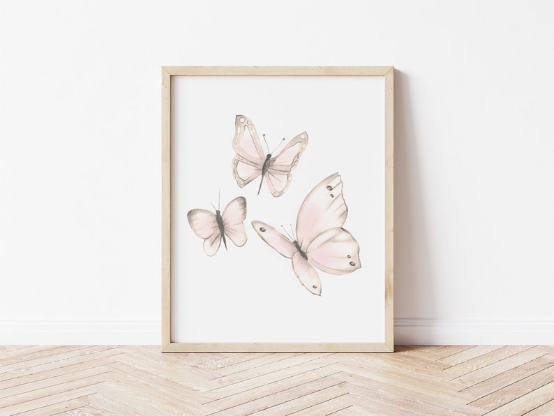 May include: A framed print featuring three delicate pink butterflies with gray outlines, set against a white background.