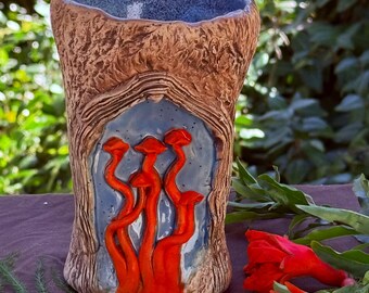 Hand sculpted ceramic pottery mug or cup for coffee tea or beer or wine with orange mushrooms