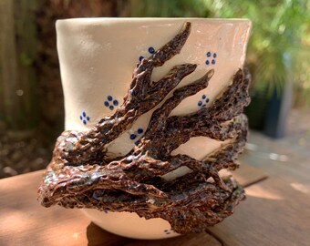 Wheelthrown and hand sculpted ceramic pottery cup vase or vessel with tree branches and flowers blue and white