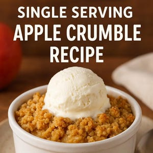 May include: A single-serving apple crumble recipe is presented in a white ramekin, topped with a scoop of vanilla ice cream. The crumble is golden brown, and the dessert sits on a beige plate with a spoon. The text "SINGLE SERVING APPLE CRUMBLE RECIPE" is at the top.