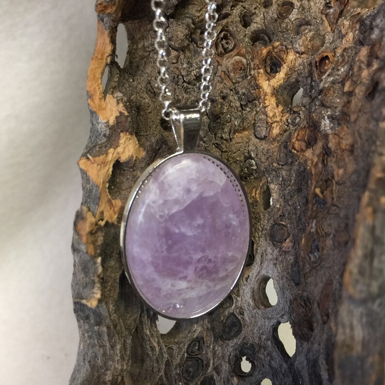 Handmade pendant necklace made from a light colored Banded Amethyst Cabochon